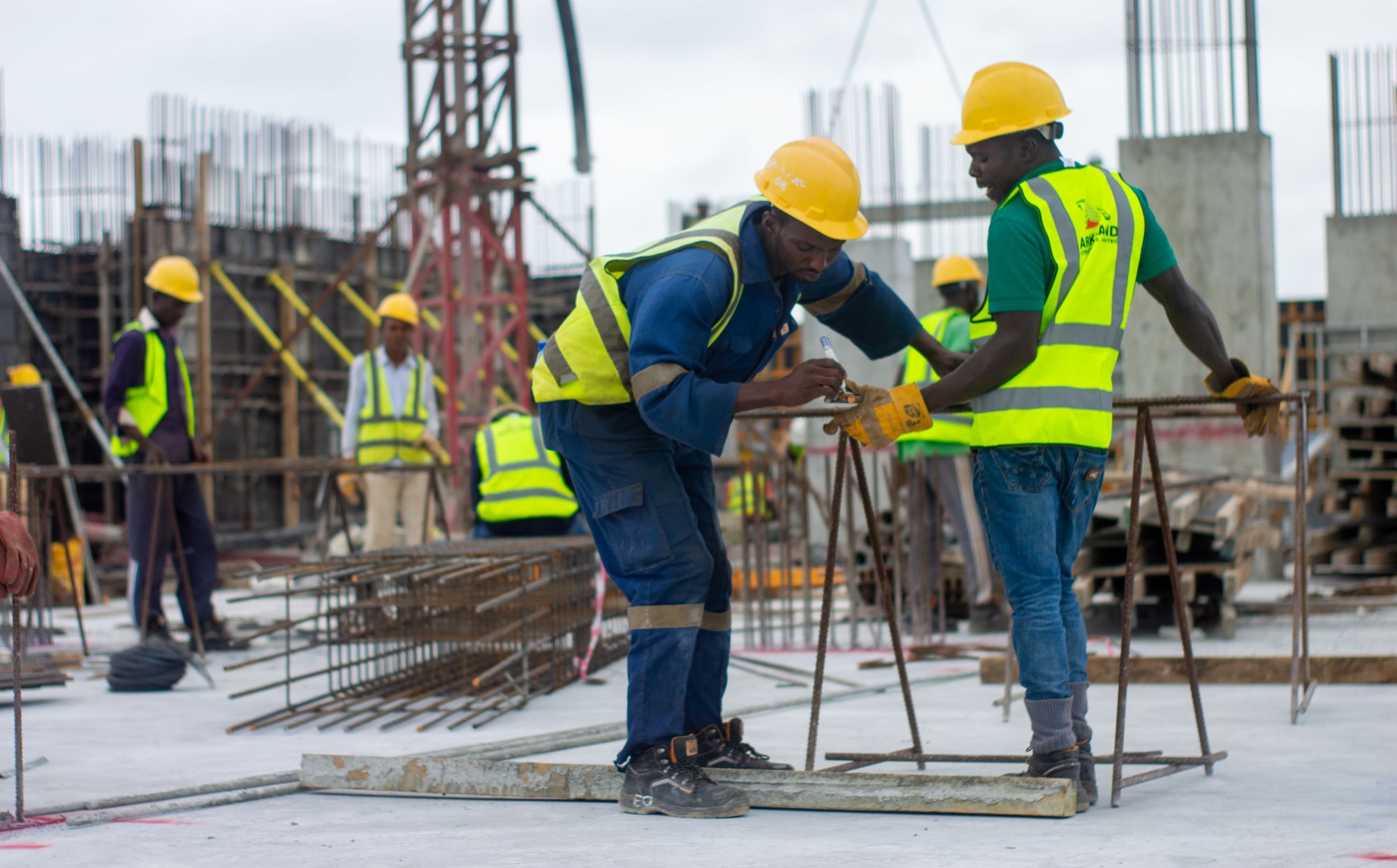 Construction workers in safety gear on a building site