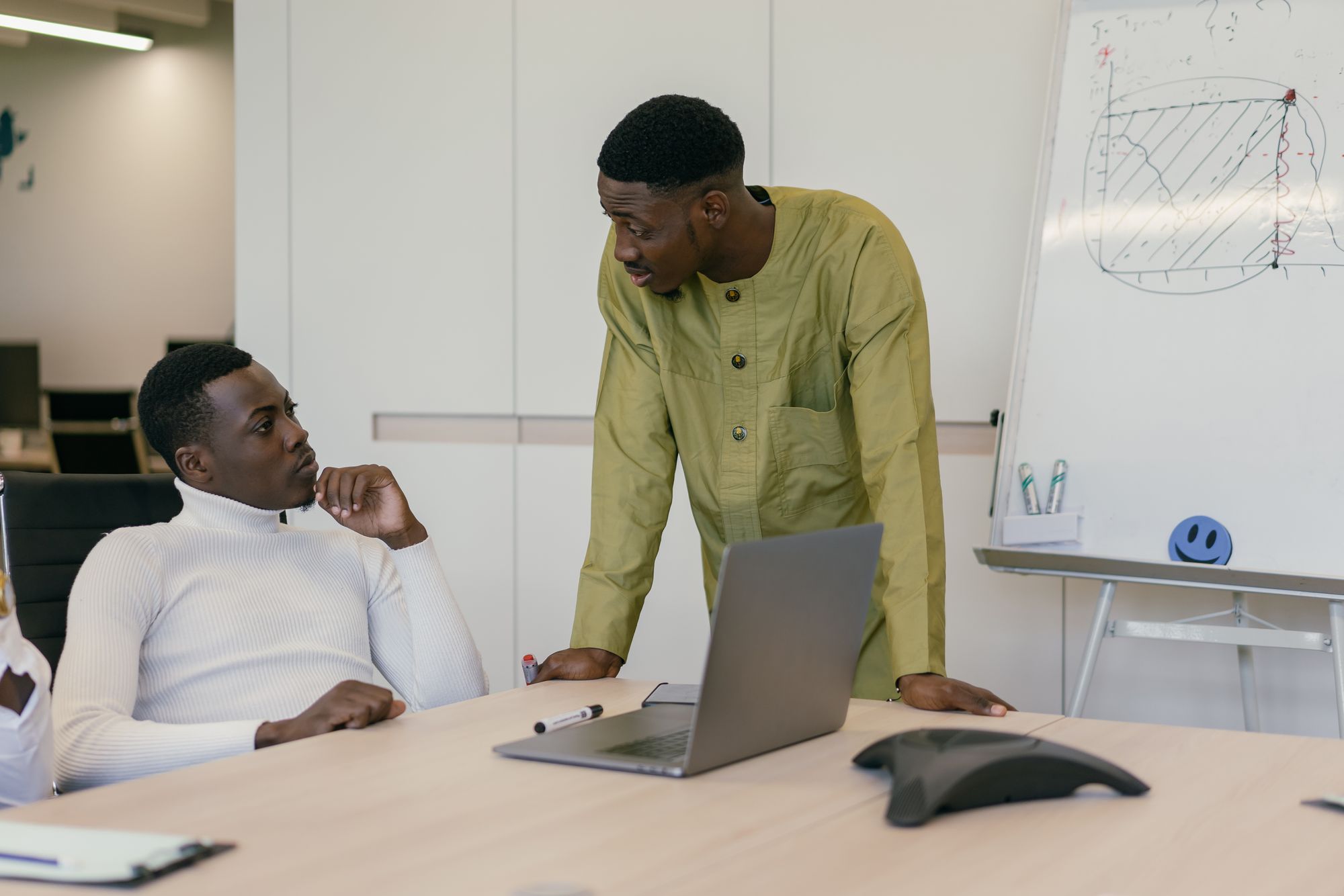 Two professionals discussing strategy in a modern office